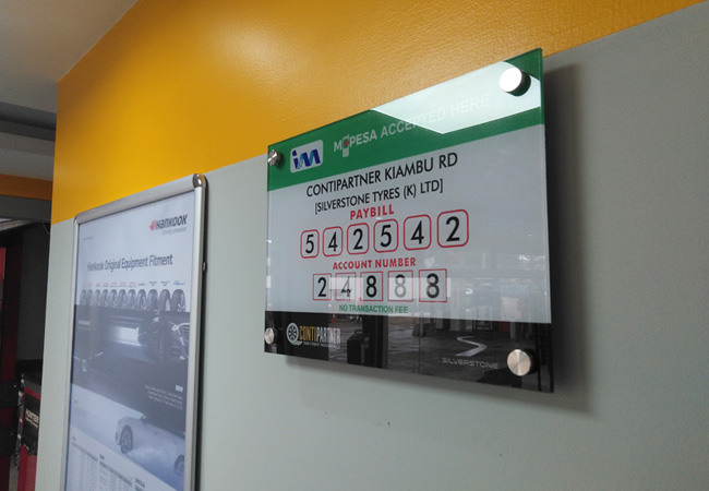 hh acrylic sign and snapper frame on wall